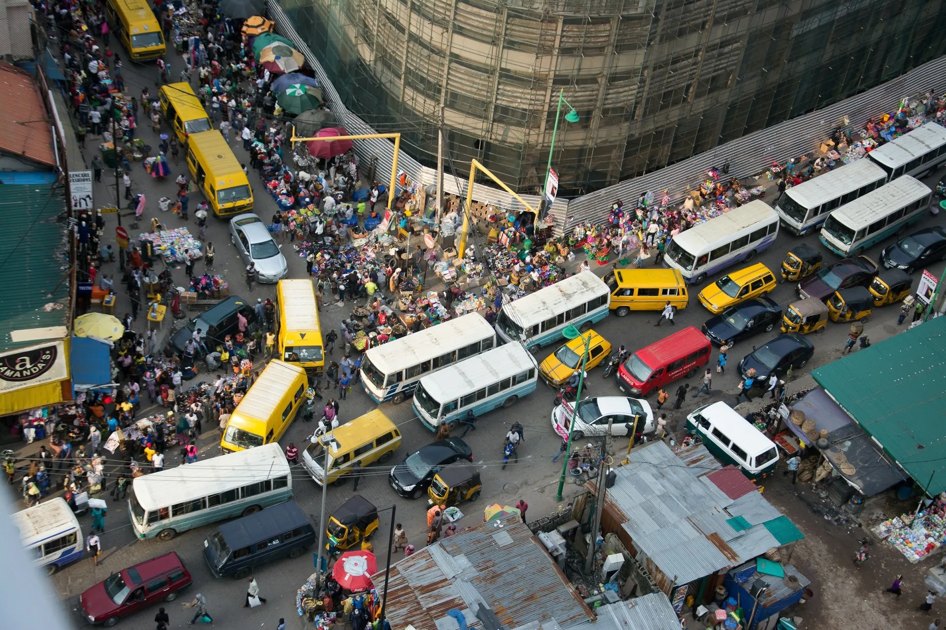 Buses, cars and market traders packed into the streets of Idumota, Lagos Island, seen from above.